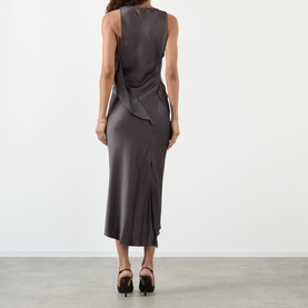 Model wearing Victoria Beckham Ore satin midi dress, back view with draped detail, styled with black heeled mules.