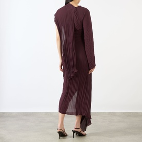 Model wearing Victoria Beckham Acai pleated midi dress with one-sleeve design, styled with black heeled mules, rear view.