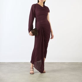 Model wearing Victoria Beckham Acai dress with asymmetric neckline, one-sleeve design and ruched skirt; styled with strappy heels and clutch bag