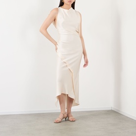 Model wearing cream sleeveless midi dress with ruffle asymmetric hem, styled with nude strappy heeled sandals