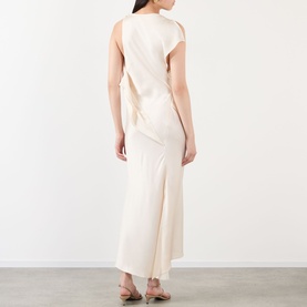 Model wearing cream sleeveless maxi dress with draped back detail and side split, shown from rear angle