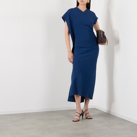 Model wearing Victoria Beckham Dark Ocean blue midi dress in viscose, styled with brown mini bag and black strappy heeled sandals.