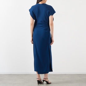 Model wearing Victoria Beckham Dress in Dark Ocean, back view, midi length with side split and short sleeves, styled with black heeled mules.
