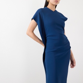 Model wearing Victoria Beckham Dark Ocean blue draped cap-sleeve midi dress with asymmetric shoulder detail, styled with gold earrings