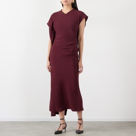 Model wearing Victoria Beckham Victoria Draped Dress in Cinnabar Red, midi length with asymmetric sleeves and draped silhouette, styled with black