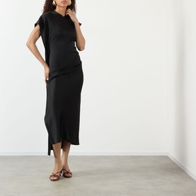 Model wearing Victoria Beckham black midi dress in acetate-viscose blend, cap sleeves, asymmetric hem, styled with tan strappy flat sandals.