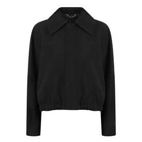 Victoria Beckham black cropped jacket with wide collar, half-zip detail, and elasticated hem, shot flat on white background.