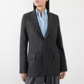 Model wearing Victoria Beckham Ore Melange tweed jacket, styled with a light blue shirt, two-button front and flap pockets visible