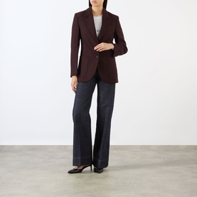 Model wearing Victoria Beckham Alina High-Rise Flared Leg Jeans in indigo, styled with a burgundy blazer and black heels.