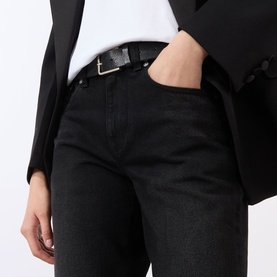 Model wearing Victoria Beckham Washed Black jeans, styled with a black blazer, white tee and black leather belt with silver buckle.