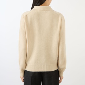 Model wearing Victoria Beckham knitwear in Elderflower, rear view, open collar, long sleeves, styled with black wide-leg trousers