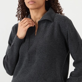 Model wearing Victoria Beckham Genevieve Knitted Polo Sweater in Ore Melange, featuring polo collar, V-neckline and ribbed trims