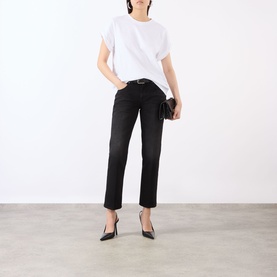 Model wearing Victoria Beckham white T-shirt, styled with black straight-leg jeans, black clutch bag and pointed-toe heels.