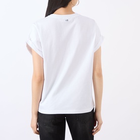 Model wearing Victoria Beckham white T-shirt, back view, with rolled sleeves, styled with black jeans