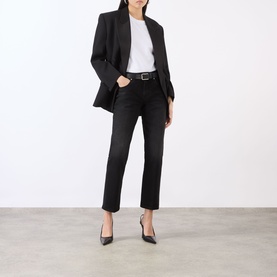 Model wearing Victoria Beckham white T-shirt styled with black blazer, cropped dark jeans, black belt and black pointed heels.