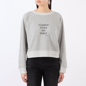 Model wearing Victoria Beckham Grey Marl Fashion sweatshirt with "Fashion Stole My Smile" slogan, cropped fit, styled with black jeans