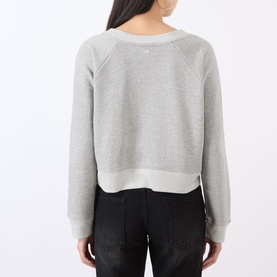 Model wearing Victoria Beckham grey marl cropped sweatshirt, back view, styled with black jeans