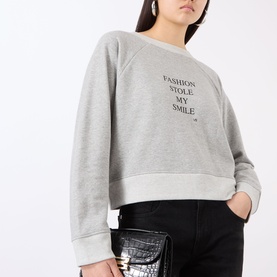 Model wearing Victoria Beckham Grey Marl Fashion sweatshirt with slogan print, styled with black croc-effect clutch bag
