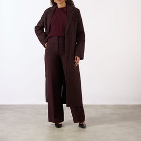 Model wearing Victoria Beckham Alina High-Rise Wide Leg Trousers in Acai, styled with matching wide-leg coord and burgundy ribbed top.