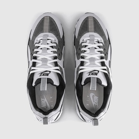 Nike trainers in vast grey and white with black accents, textured upper panelling, white laces and branded tongue, top-down view