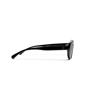 Chanel black sunglasses with glossy acetate frames, slim temples, and subtle logo detail, shown from a side profile angle.