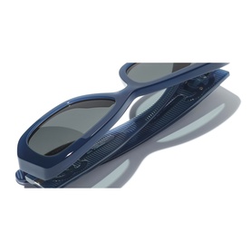 Chanel blue sunglasses, top-down view showing frame profile, dark lenses and textured temple arms