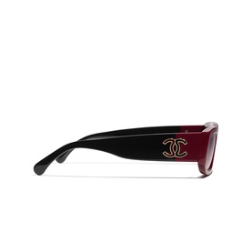 Chanel rectangle sunglasses in red and black with gold CC logo hardware, shown from the side