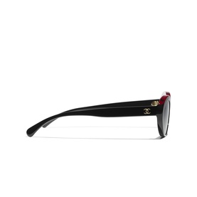 Chanel sunglasses in black and red with gold CC logo hardware, shown from the side profile view