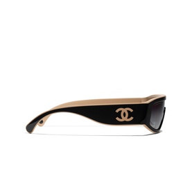 Chanel sunglasses in black and beige with gold CC logo on temple, wraparound frame, gradient lenses