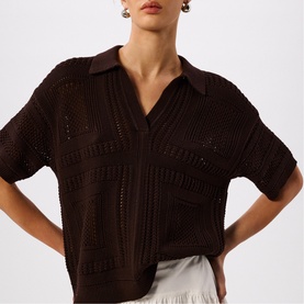 Model wearing Whistles brown open-knit pointelle polo shirt with short sleeves, styled with a white skirt