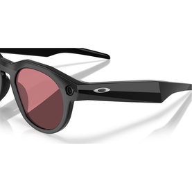 Oakley black sunglasses with round frames, silver logo detail on temple, and rose-tinted lenses, shown at close angle.