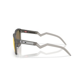 Grey and gold Oakley sunglasses shown from rear angle, highlighting temple arms with red accent detail and gold mirrored lenses
