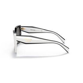 Prada sunglasses in black and white with gold-tone temple branding, shown stacked from side angle with dark lenses