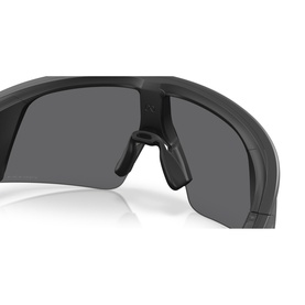 Oakley black sunglasses with wraparound shield lens, matte black frame, and rubberised nose bridge, close-up detail shot