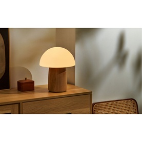 Gingko mushroom-shaped table lamp with frosted white glass shade and natural wood base, styled on a wooden sideboard
