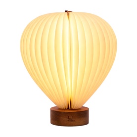 Gingko hot air balloon-shaped table lamp with cream ribbed paper shade and warm wood circular base, illuminated