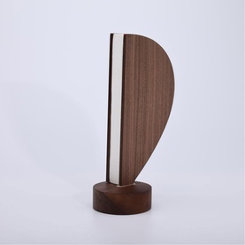 Gingko light in walnut-toned wood with cream panel detail, teardrop-shaped body on circular base