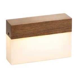 Rectangular table lamp with dark wood-effect top and glowing frosted white base emitting warm light