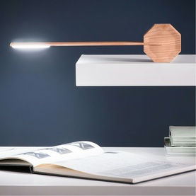Gingko octagonal wooden desk lamp with slim LED arm, mounted on white shelf above open book on white desk