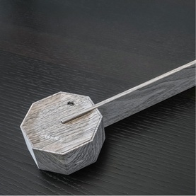 Gingko geometric wooden incense or pen holder with slim rod, in weathered grey oak finish, on dark surface.