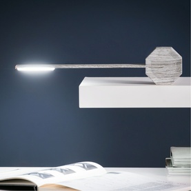 Gingko slim desk lamp with geometric base, extended arm, and LED strip light, styled on a white shelf against a dark blue wall