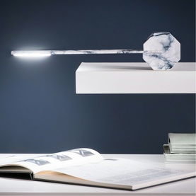 Gingko White Marble LED desk lamp with octagonal base, extended over an open book on a white desk against a blue wall