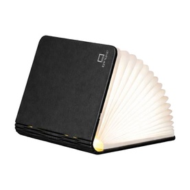 Gingko Smart Book Light in Space Black, open fan-shaped pages emitting warm white glow, faux leather cover finish