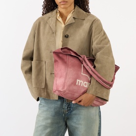 Model carrying Isabel Marant Yenky Logo Medium Tote Bag in raspberry canvas, with embroidered logo. Styled with beige jacket and jeans.