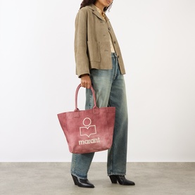 Model carrying Isabel Marant Yenky Logo Medium Tote Bag in raspberry canvas with embroidered logo, styled with beige jacket and jeans