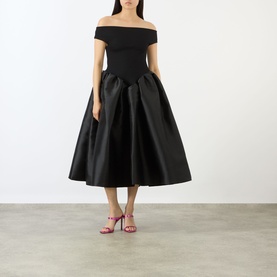 Model wearing Marques Almeida Mikado Princess Dress in black, off-shoulder fitted bodice, full midi puff skirt, styled with pink heeled sandals.