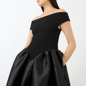 Model wearing Marques Almeida Mikado Princess Dress in black, off-the-shoulder bodice with voluminous mikado puff skirt and side pockets.