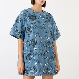 Model wearing Marques Almeida Sequin Embroidered Mini Denim Dress in mid blue with floral sequin embellishment, short sleeves, round neckline