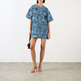 Model wearing Marques Almeida Sequin Embroidered Mini Denim Dress in mid blue with floral sequin detail, styled with red heeled sandals and black