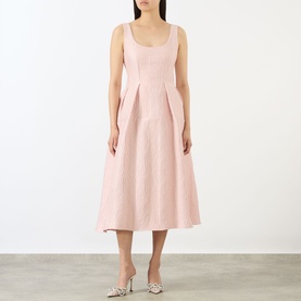 Model wearing Marques Almeida Pink Textured Brocade Dress with scoop neckline, sleeveless midi silhouette and pleated skirt detail.